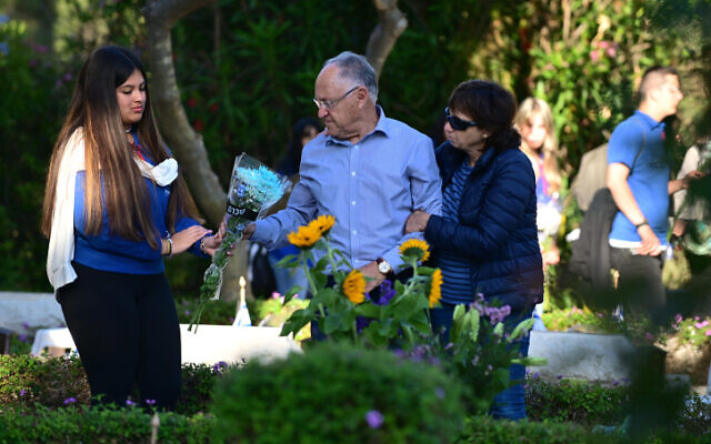 Des membres de la famille et des amis se rendant, à Yom Hazikaron, sur les tombes des soldats tombés au combat au cimetière militaire de Kiryat Shaul, à Tel Aviv, le 25 avril 2023. (Tomer Neuberg/Flash90)