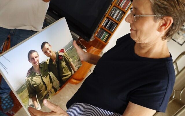 Leah Goldin, la mère du lieutenant Hadar Goldin, regarde une photo de son fils, dont la dépouille est retenue en otage par le Hamas dans la bande de Gaza, pendant une interview avec l'AFP à son domicile de Kfar Saba, le 29 août 2018. (Crédit : / AFP PHOTO / JACK GUEZ
