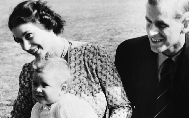 Le prince Charles, devant à gauche, fils de huit mois de la princesse Elizabeth d'Angleterre, à gauche, et du duc d'Édimbourg, pose pour l'appareil photo avec sa mère sous le regard de son père, le 18 juillet 1949, à Ascot, en Angleterre. La photo a été prise sur la lande de Windlesham, leur résidence d'été. (Crédit : AP Photo)