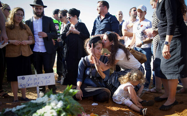 Tal Tamari et ses enfants lors de l'enterrement de son mari Meir dans l’implantation de Shaked, le 31 mai 2023. (Crédit : Shir Torem/Flash90)