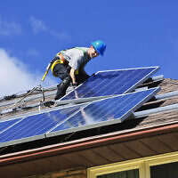 Photo d'illustration : Installation de panneaux solaires sur un toit. (Crédit : lenathewise, iStock at Getty Images)