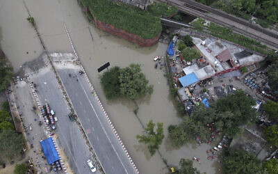 Une route inondée par l'eau du fleuve Yamuna, à New Delhi, en Inde, le 15 juillet 2023. (Crédit : AP Photo/Piyush Nagpal)