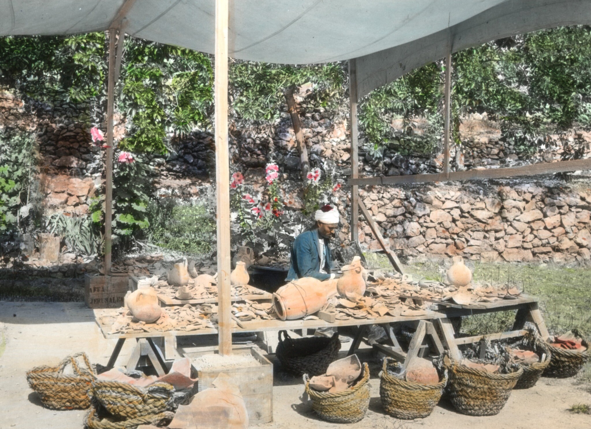 L'ouvrier en chef Reis Mahmoud Kureyim restaurant des poteries sur la terrasse de la maison des fouilles, en mai 1929. (Crédit : Musée Badè/École de religion du Pacifique)
