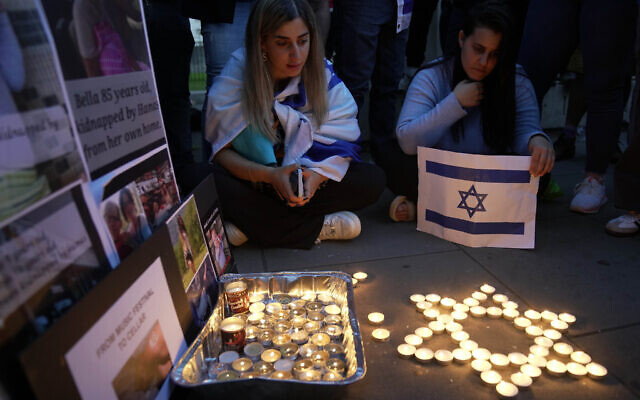Des personnes allumant des bougies lors de la "Veille de la communauté juive" pour Israël à Londres, le 9 octobre 2023, deux jours après que les terroristes du Hamas ont lancé une attaque multi-frontale sans précédent contre Israël, qui a tué plus de 1 000 personnes. (Crédit : Kin Cheung/AP Photo)