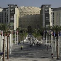 Des personnes traversant le lieu du sommet climatique de l'ONU COP28 avec le dôme al-Wasl en arrière-plan à Expo City, à Dubaï, aux Émirats arabes unis, le 29 novembre 2023. (Crédit : Joshua A. Bickel/AP Photo)
