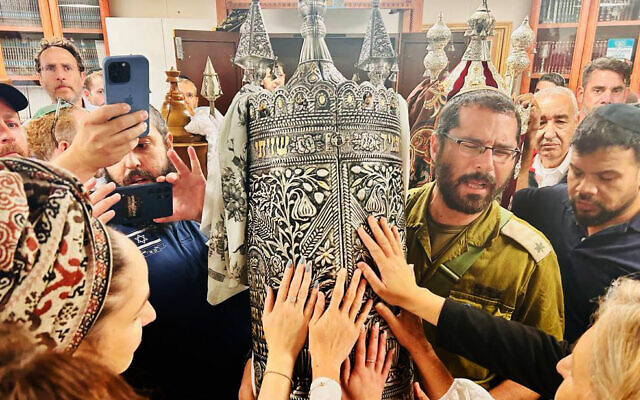 Les résidents du kibboutz Beeri et des visiteurs inaugurent un rouleau de Torah dans la synagogue du kibboutz en mémoire d'Amit Man, tuée, avec de nombreux autres, par les terroristes du Hamas le 7 octobre, le 27 novembre 2023. (Autorisation : Famille d'Amit Man)