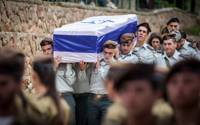 La famille et les amis du commandant du 13e bataillon de la brigade Golani, le lieutenant-colonel Tomer Grinberg, lors de ses funérailles au cimetière militaire du Mont Herzl à Jérusalem, le 13 décembre 2023. (Crédit : Yonatan Sindel/Flash90)