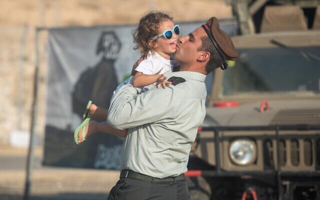 Le lieutenant-colonel Tomer Grinberg embrassant sa fille, Arbel, en juillet 2023. (Crédit : Porte-parole de l’armée israélienne)