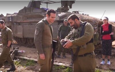 Le commandant adjoint Maj. Idan (à droite) du bataillon Rotem de la Brigade Givati restitue un portefeuille et un médaillon que Yedid Ackerman (à gauche) a perdus pendant la guerre Israël-Hamas en 2014. (Capture d'écran vidéo de Ynet ; utilisée conformément à la Clause 27a de la Loi sur le droit d'auteur).