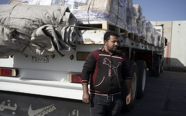 Abdullah, un chauffeur de camion égyptien, attend de livrer une cargaison d'aide humanitaire destinée à la bande de Gaza dans une zone de stockage à la frontière de Kerem Shalom, entre la frontière israélo-égyptienne et israélo-gazaouie, le 10 janvier 2024. (Crédit : AP/Maya Alleruzzo)