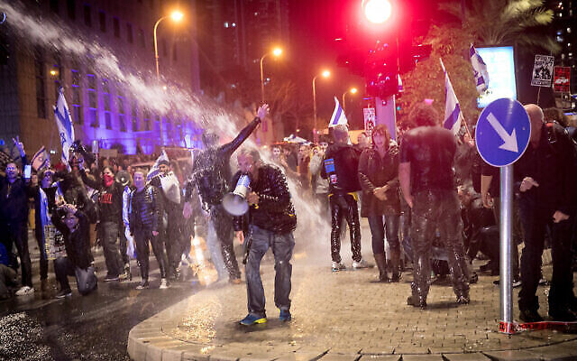 La police utilise un canon à eau pour disperser les manifestants qui s'opposent au gouvernement et au Premier ministre Benjamin Netanyahu à Tel Aviv, le 24 février 2024. (Crédit : Miriam Alster/Flash90)