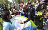 Des manifestants de l'Université de Californie du Sud se battent avec des agents de la sécurité publique de l'Université qui tentent de retirer les tentes du parc des anciens élèves suite à un mouvement d'occupation pro-palestinien et anti-israélien à Los Angeles, le 24 avril 2024. (Crédit : Richard Vogel/AP)