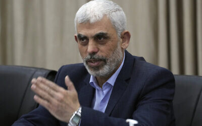 Yahya Sinwar, le chef du Hamas à Gaza, saluant ses partisans pendant une rencontre de factions palestiniennes, dans son Bureau de Gaza City, le 13 avril 2022. (Crédit : Adel Hana/AP)