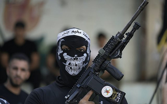 Des membres palestiniens armés du groupe militant du Jihad islamique défilant lors d'un rassemblement marquant le 35e anniversaire de la fondation du mouvement, dans le camp de réfugiés de Jénine, en Cisjordanie, le jeudi 6 octobre 2022. (AP Photo/Majdi Mohamed)