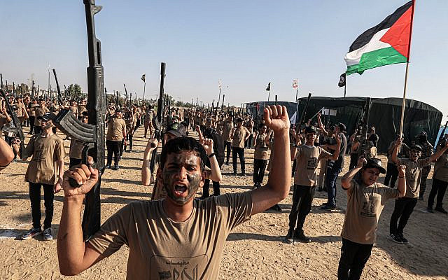 Des jeunes Palestiniens avec de fausses armes pendant un camp d'été militaire organisé tous les ans par le groupe terroriste du Djihad islamique palestinien à Khan Younès, dans le sud de la bande de Gaza, le 22 juin 2023. (Crédit : SAID KHATIB / AFP)