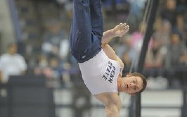 Felix Aronovich performs a handstand as a Penn State gymnast during a recent collegiate competition. (PSU Athletics/Mark Selders)