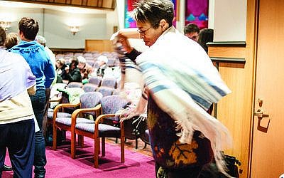 Esther Chaya Batsarah of Swissvale wraps herself in a tallit, Sunday, Oct. 28, at Rodef Shalom Congregation before she and more than 100 others protest the arrest of Anat Hoffman at a “Shema-in.” Hoffman was arrested Oct. 16 for reciting the Shema at the Western Wall in Jerusalem. Female attendees at the Shema-in wore tallitot to support Hoffman and her organization, Women at the Wall. (Chronicle photos by Lindsay Dill)
