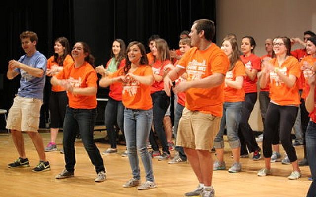 J-Serve began Sunday with a flash mob dance to get teens motivated for a day of volunteering. Below, bad weather didn’t stop 250 Jewish teens from boarding buses outside the Jewish Community Center in Squirrel Hill and traveling to 17 different sites throughout Pittsburgh as a part of J-Serve. (J-Serve photo)