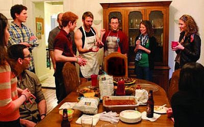 Members of Moishe House Pittsburgh recently held a food-centered event similar to the one pictured above. The event, paid for by a “micro-grant” from the Jewish Agency for Israel, was an Iron chef-style contest for hummus lovers. (Photo by Naomi Fireman)