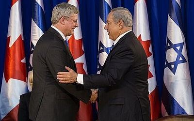 Israeli Prime Minister Benjamin Netanyahu (right) shakes hands with Canadian Prime Minister Stephen Harper during a welcoming ceremony for Harper at Netanyahu’s office in Jerusalem on Jan. 19. Harper took a four-day trip to Israel and the Palestinian territories. (Flash90 photo)