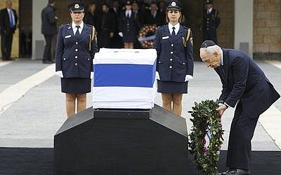 Israeli President Shimon Peres pays his respects at the coffin holding former Israeli Prime Minister Ariel Sharon, laid outside the Knesset. Sharon passed away Saturday, Jan. 11. (Miriam Alster/FLASH90)