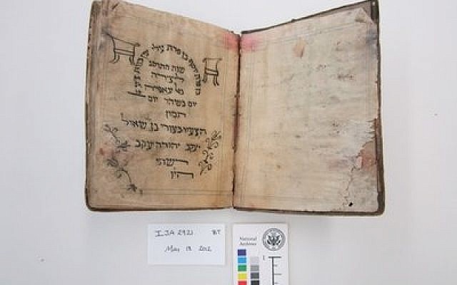 Before treatment by the National Archives and Records Administration, a Passover haggadah from 1902 recovered from the Mukhabarat, Saddam Hussein’s Intelligence Headquarters. The haggadah is part of what has become known as the Iraqi Jewish Archive. (Credit: National Archives and Records Administration)
