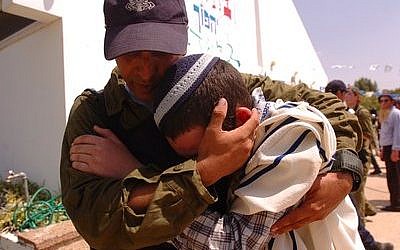 An Israeli soldier comforts a Jewish resident while evacuating the Israeli community of Morag during the August 2005 unilateral Israeli disengagement from Gaza.  Unilateralism has been a taboo subject in Israel since the perceived failure of the Gaza disengagement due to the rise of the terrorist group Hamas there, but a growing number of respected Israeli leaders are proposing unilateral moves in the wake of the recent Palestinian unity pact between Fatah and Hamas.