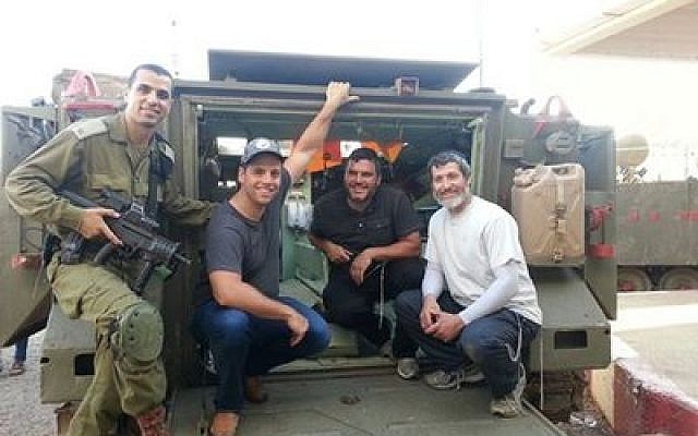 The "Pittsburgh Relief Mission" packed trucks and delivered supplies to the troops in the north on their trip to Israel. Next to the soldier, from left, are Daniel Berkowitz, Daniel Kraut and Rabbi Daniel Wasserman.