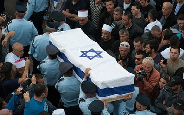 Members of the Israeli police carry the coffin of Druze police officer Zidan Saif during his funeral in the northern village of Yanuh-Jat on Nov. 19. Saif was killed while trying to save Jewish worshippers from Palestinian terrorists who had attacked a Jerusalem synagogue.
(Photo by Flash90)