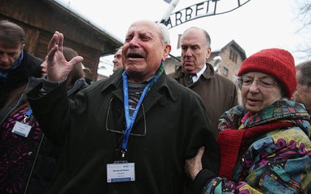 Mordechai Ronen, who was a prisoner at the Auschwitz concentration camp when he was 11 and lost his mother, father and sisters there, breaks into tears as he walks through the camp, which is now a museum. (Photo by Sean Gallup/Getty Images)