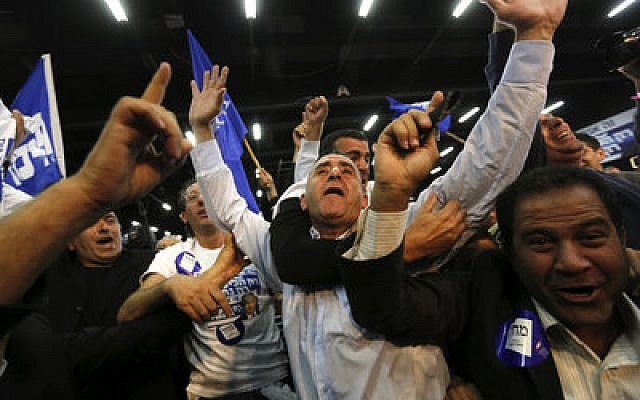 Likud Party supporters in Tel Aviv react after hearing exit poll results, which showed that Prime Minister Benjamin Netanyahu's Likud Party had surged ahead of Isaac Herzog's Zionist Union in Tuesday’s election.