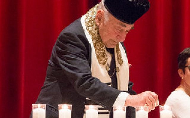 Cantor Moshe Taube lights a candle during the candle-lighting ceremony. (Photo provided by the Holocaust Center of Pittsburgh/Melanie Friend Photography)