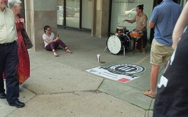 PJ Roduta, a busker, drums at the new street stage in Squirrel Hill. (Photo by Adam Reinherz)