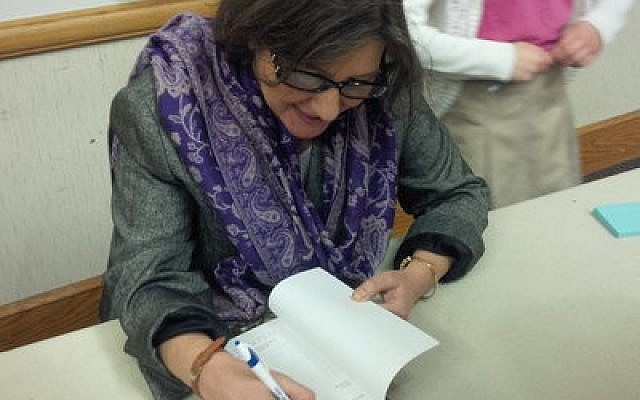 Beth Kissileff signs a copy of “Reading Genesis: Beginnings.” 
Photo by Adam Reinherz