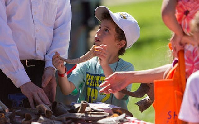 Caleb Knoll, 7, shows off a shofar. Shalom Pittsburgh’s festival introduced many youngsters to the shofar’s role in Rosh Hashanah.