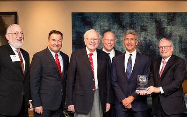 From left: Harold F. Marcus, executive director of Israel Bonds Pennsylvania; Israel Maimon, president and CEO of Development Corporation for Israel/Israel Bonds; Warren Buffett; Stuart Garawitz, Israel Bonds national vice president for sales; Henry Davis, president of Greater Omaha Packing Co., Inc.; and Izzy Tapoohi, immediate past president and CEO of Israel Bonds.			              Photo by Stacie Kinney, Friedland Studio