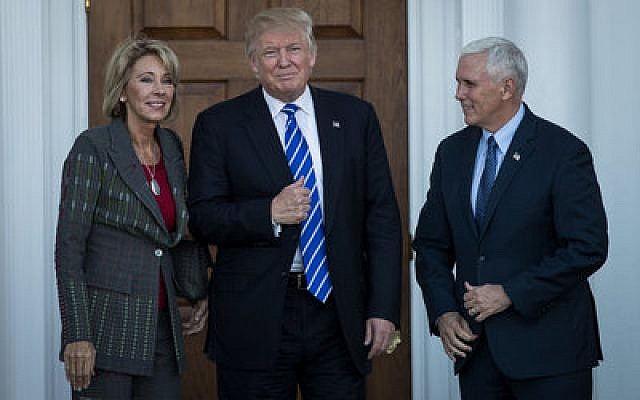 Betsy DeVos, President-elect Donald Trump and Vice President-elect Mike Pence pose for a photo outside the clubhouse at Trump International Golf Club in Bedminster Township, N.J.
Photo by Drew Angerer/Getty Images
