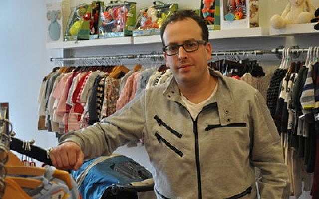 Paul Kenney owns Kidz & Company, a children’s clothing store on Forbes Avenue. 
Photo by Adam Reinherz