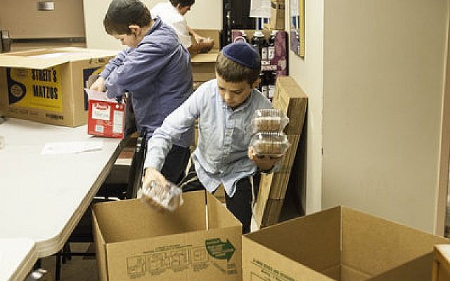 Students from Yeshiva Boys School packed food for inmates in correctional institutions and patients in state hospitals and group homes last week at the Aleph Institute. 

Photo provided by Rabbi Moishe Mayir Vogel