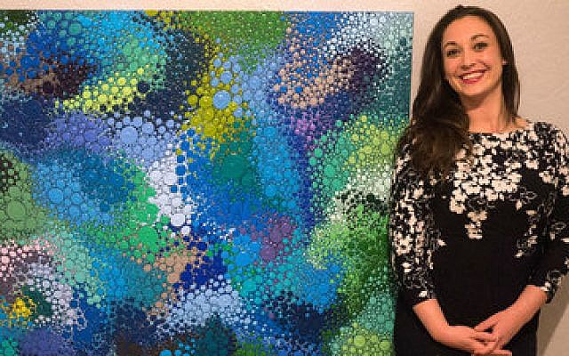 Artist Sara O’Connor stands beside one of her paintings.	
(Photo courtesy of Sara O’Connor)