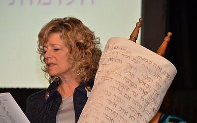 Lynn Magid Lazar cradles the Torah of Women of Reform Judaism as she is installed for her second term as president of the affiliate of the Union for Reform Judaism.  Avigayil Halpern has wokred to include women's voices into her Torah study. (Photo courtesy of Dale Lazar)