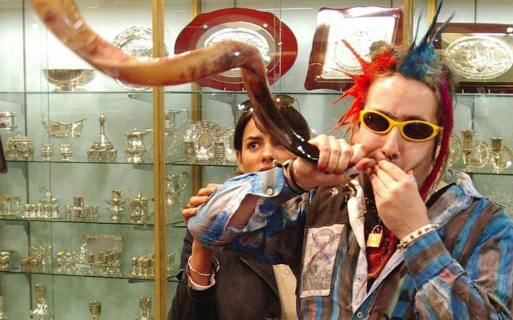 Bram Presser of the band Yidcore blows a shofar at a Judaica store in Melbourne, Australia. 	 Photo by Peter Haskin