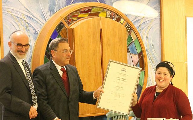 Rabbi Shuki Reich, left, seminary head of the Susi Bradfield Women’s Institute of Halakhic Leadership, and Rabbi Shlomo Riskin, chancellor of Ohr Torah Stone, present Rabbanit Shira Zimmerman with her certification as a spiritual leader and arbiter of Jewish law at a ceremony in Jerusalem. 


Photo courtesy of Ohr Torah Stone