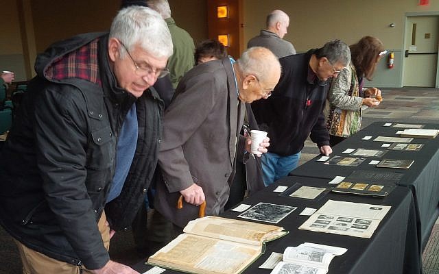 Onlookers observe World War I related materials during the Nov. 12 program at the Heinz History Center. (Photo by Adam Reinherz)