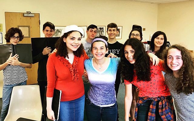 HaZamir Pittsburgh teens pose for a photo during one of their weekly rehearsals. Back row, from left: Zev Haworth, Max Rosen, Joey Breslau, Eitan Weinkle, Yael Perlman and Naomi Frim-Abrams; front row, from left: Sarah Krastman, Ada Perlman, Dana Engel and Dori Catz. (Photo courtesy of Molly D. May)
