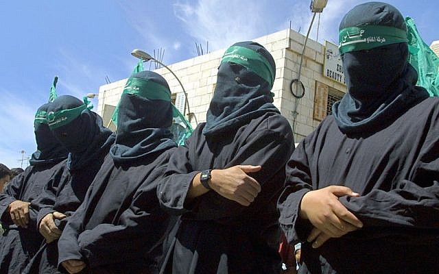 Masked Hamas militants mourning a suicide bomber at a symbolic funeral in Ramallah, March 29, 2001. (Photo by David Silverman /Newsmakers)