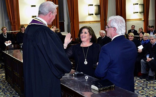 Supreme Court Justice Kevin M. Dougherty swears in Ellen Ceisler on a Bible held by her fiancé, Chris Gorson. (Photo courtesy of Ceisler campaign)