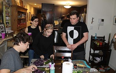 Base Hillel participants prepare food for the homeless. (Photo by Ben Sales)