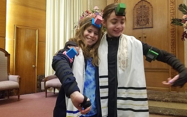Haley Levine and Gabi Zimmerman, fifth-graders at Torah Lishmah Community, the religious school of Tree of Life*Or L’Simcha Congregation, participated in the World Wide Wrap and modeled their tefillin.  (Photo courtesy of Torah Lishmah Community)