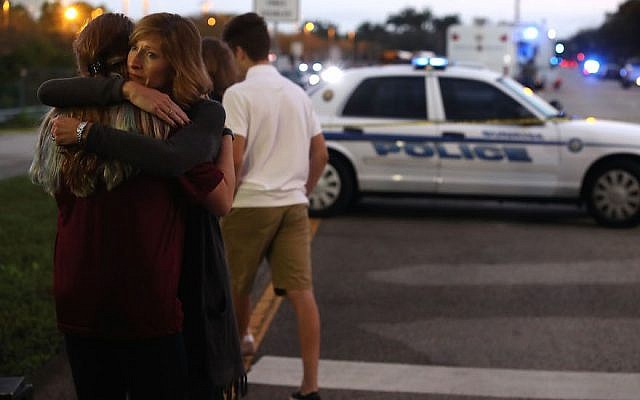 Kristi Gilroy hugs a young woman at a police checkpoint near the Marjory Stoneman Douglas High School. (Photo by Mark Wilson / Getty Images)